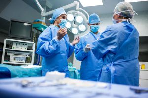 درباره ما 2 surgeons interacting with each other operation room